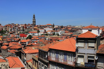 Obraz premium Beautiful facades and roofs of houses in Porto, Portugal, and the bell tower of Torre dos Clerigos