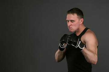 Portrait of aggressive fighter or boxer man isolated on gray background. Concept photo.