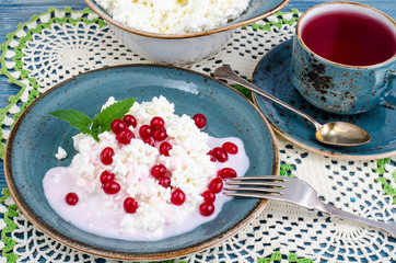 Homemade fresh cottage cheese with yogurt and red berries, tea