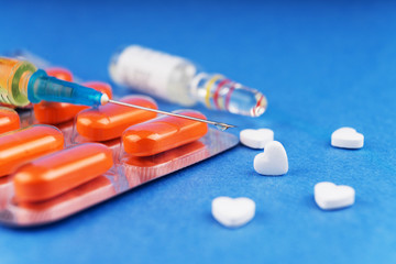 Tablets in a blister, a syringe with the typed medical preparation, an ampoule with a...