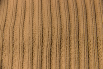 texture of knitted stripes of beige yarn