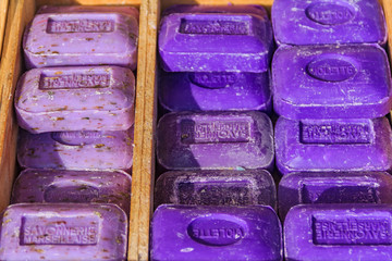 Colorful natural handmade avender and violet scented oap in wooden boxes at a market in Marseille Provence France