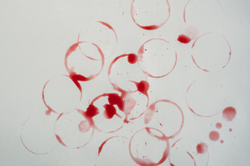 Spots of red wine on the white table. Top view