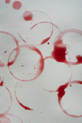 Spots of red wine on the white table. Top view