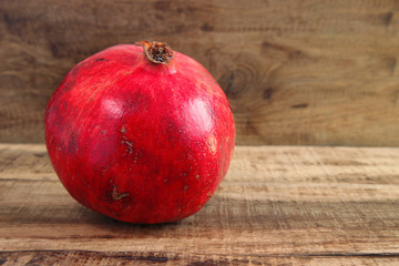 red pomegranate on wooden background