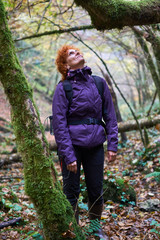Hiker lady with backpack in the forest