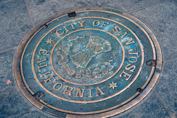 Close up of a City of San Jose, California Manhole Cover on the sidewalk in the downtown area