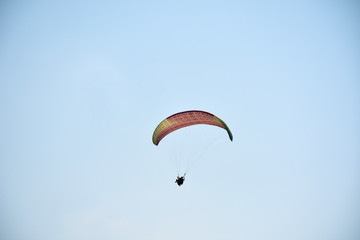 Paraglider on a clear day for background usage. Spaces for type.