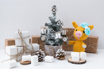 New Year Yellow pig 2019. Marshmallows. New Year's and Christmas. Christmas tree and gifts of jewelry, bracelets with charms. Huggy concept. 