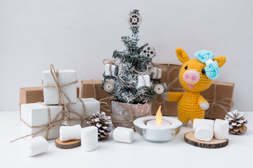 New Year Yellow pig 2019. Marshmallows. New Year's and Christmas. Christmas tree and gifts of jewelry, bracelets with charms. Huggy concept. 