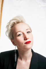 portrait of a business lady with a suit, red lips, white background, different emotions Business concept.