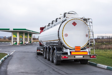 Truck with gasoline tank fuel before unloading at a gas station.