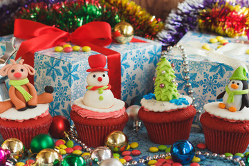 Christmas cupcakes with colored decorations, soft focus background