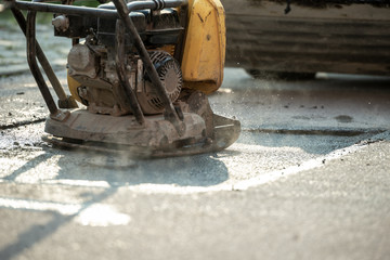 Compactor finishing the last phase of laying new asphalt