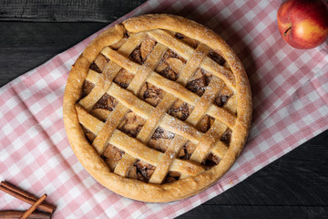 Home baked apple pie on kitchen towel. Above view.