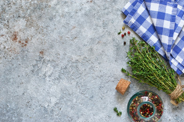 Mix of peppers and thyme on a concrete background. Food background with space for text. Advertising.