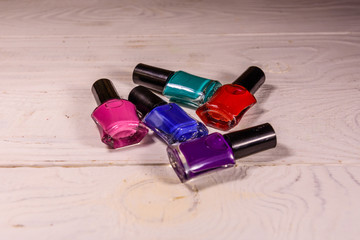 Different nail polishes on a wooden table