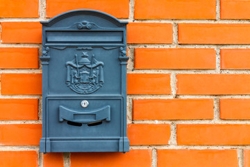 A beautiful mailbox hangs waiting for newspapers, parcels and letters.