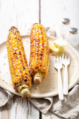 Hot and delicious corn from grill with butter and salt