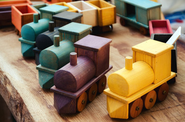 Many wooden train toys on a wood table - 234155419