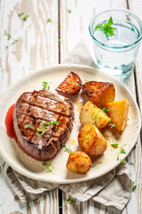 Yummy steak and roasted potatoes with salt and thyme