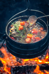 Tasty and homemade hunter's stew on bonfire
