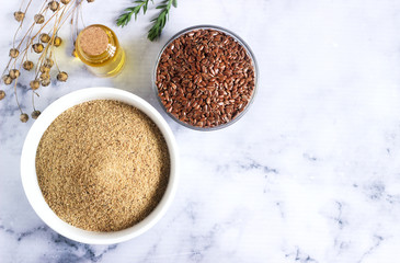Flax seeds, flax flour, oil with sprouts and flax seed boxes on a light background.