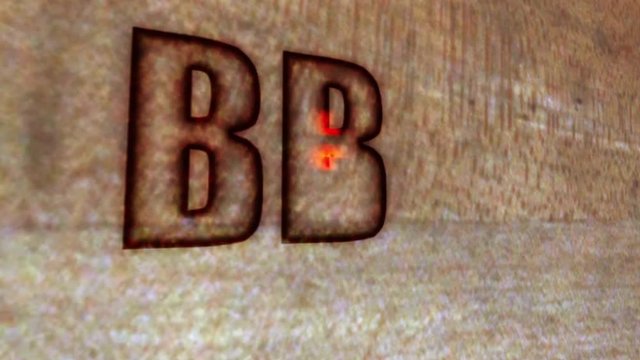 BBQ with fork and spatula burned in wooden background