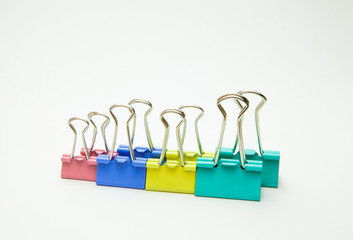 Clips for paper of different colors, close-up on a white background