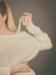 Woman holding her bra strap