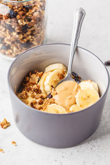 Baked granola with raisins, banana and peanut butter.