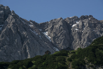 Fototapeta na wymiar Alpine lodge in front a mountain