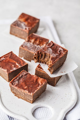 Raw Vegan Chocolate Cake Slices on white background.