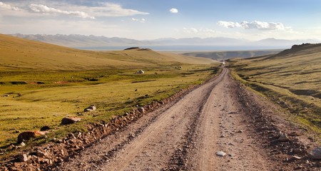 Unpaved road and yurts near Son-Kul lake in Kyrgyzstan