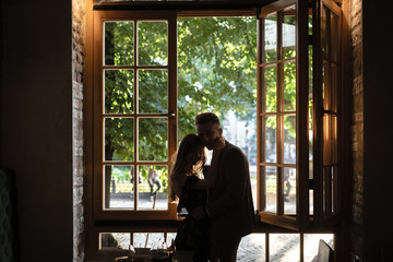 Obraz premium Young couple by the window