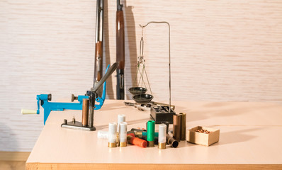 shotgun cartridges reloading. capsules, shells, powder, cartridges, scales on the table