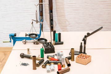 shotgun cartridges reloading. capsules, shells, powder, cartridges, scales on the table