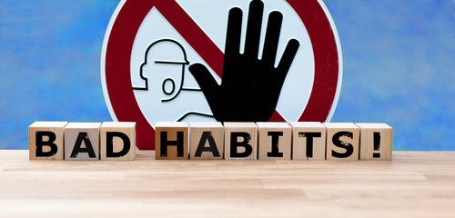 Dices form the words "BAD HABITS" infront of a stop sign