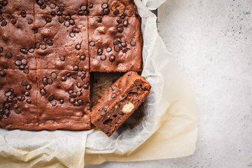 Chocolate cake with chocolate drops in a baking dish, top view.