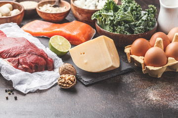 Balanced diet food background. Protein foods: fish, meat, cheese, quinoa, nuts on dark background.