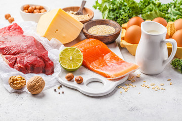 Balanced diet food background. Protein foods: fish, meat, cheese, quinoa, nuts on white background.