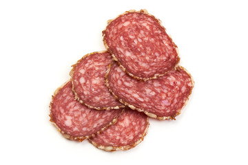 Sliced salami sausage with sunflower seeds, isolated on white background. Close-up.