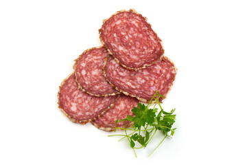 Traditional Dried Sliced Salami Sausage with parsley, isolated on white background. Close-up