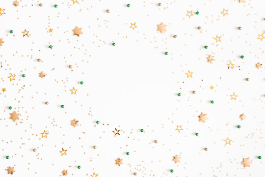 Christmas composition. Christmas green and golden decorations on white background. Flat lay, top view, copy space