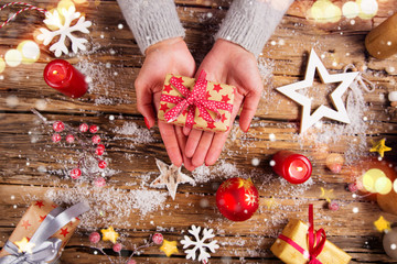 Top view of woman hands with gift box.