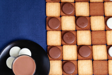 Cookie's checkers and a cup of coffee. Selective focus.