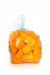 Fresh raw pumpkin pieces in plastic bag ready to be frozen in the refrigerator