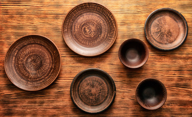 Old clay shabby plate on a yellow wooden table