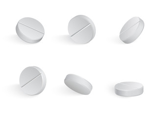 Round white medical tamblets in different positions.