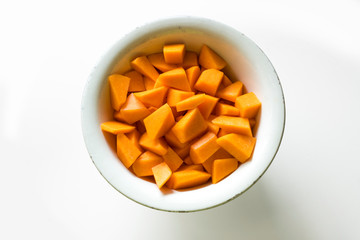 Pieces of pumpkin in a bowl, top view